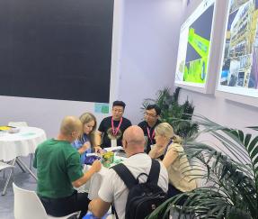 Russia  Clients Discussing The Technology And Business Of Automatic Packaging Line For Manmade Board Industry In Woodworking Exhibition